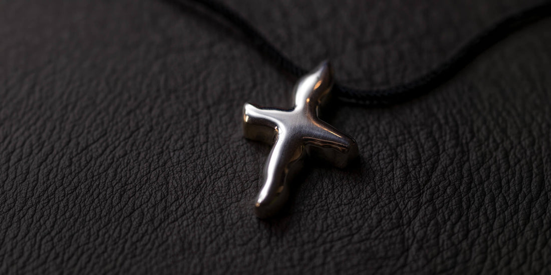Handmade sterling Silver Pendant made by Platon Vasatis on a black leather surface 