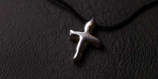 Handmade sterling Silver Pendant made by Platon Vasatis on a black leather surface 